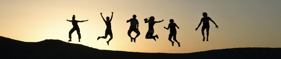 Photo of a group of friends jumping in the air at sunset by Timon Studler on Unsplash.com 